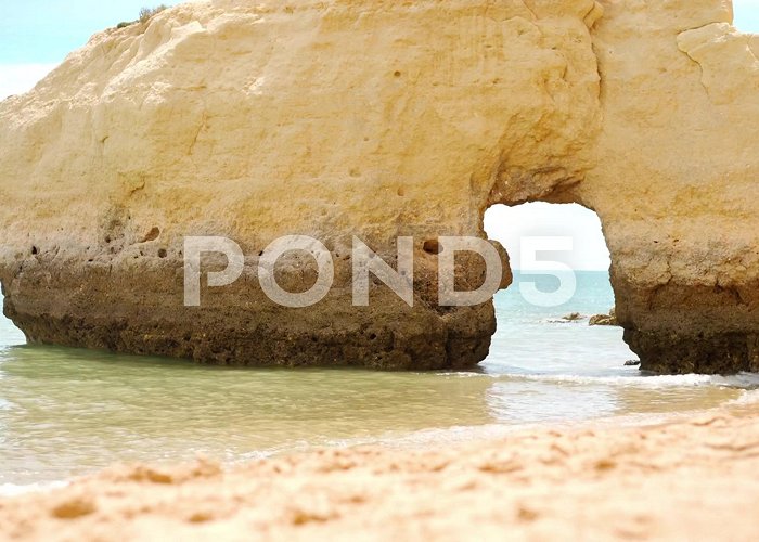 Vale do Olival Beach The rocky cliffs of Vale do Olival beach... | Stock Video | Pond5 photo